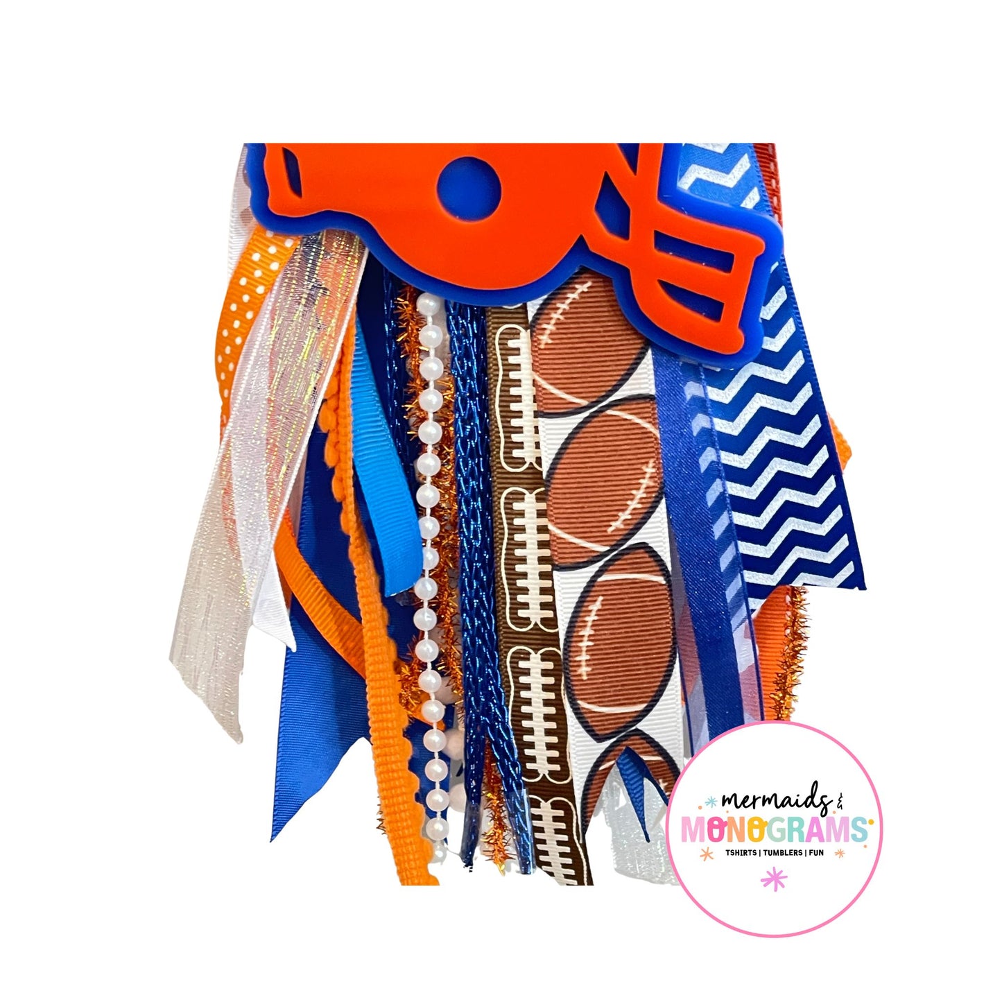 Close-up of football-themed ribbon tassel with pearls, polka dots, glitter, and football prints