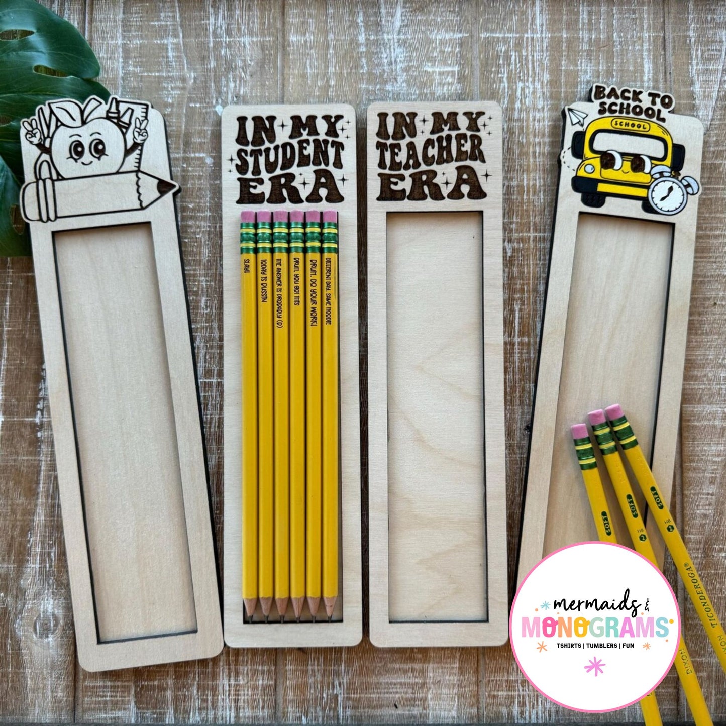 Pensils in wooden holders with 'Back to School' theme on a wooden surface