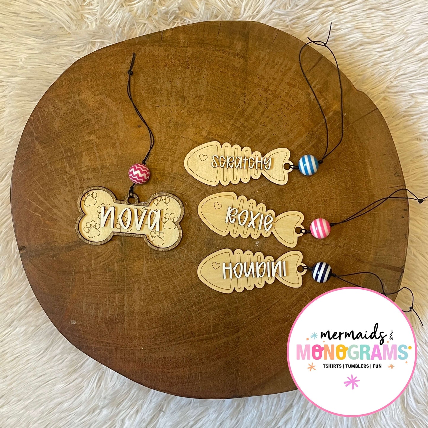 Personalized pet tags on a wooden board
