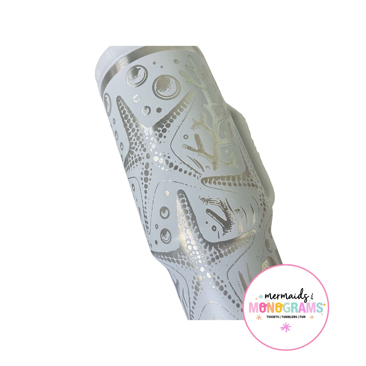 Close-up of silver etched starfish and bubbles on pastel tumbler