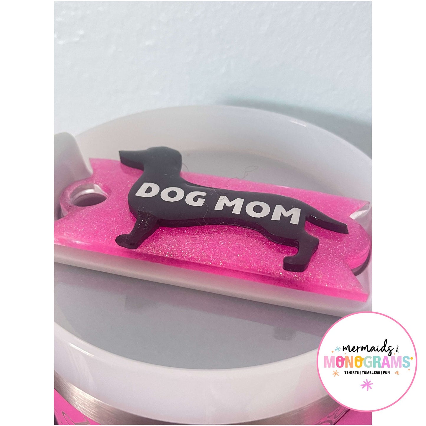 Close-up of black dog silhouette with bold white text and pink glitter base