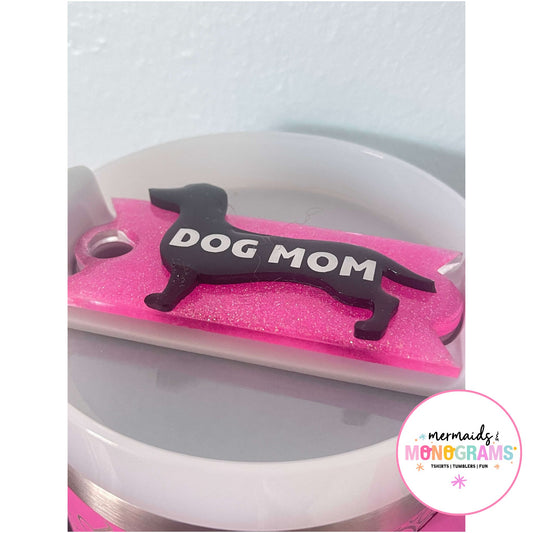 Close-up of black dog silhouette with bold white text and pink glitter base