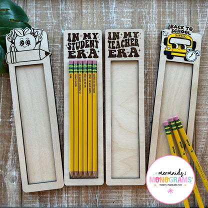Pensils in wooden holders with 'Back to School' theme on a wooden surface