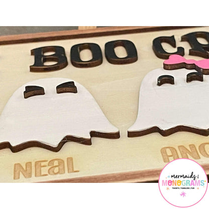 Zoomed-in Halloween Boo Crew sign showing laser engraved ghost characters and individual names like Angela and Neal