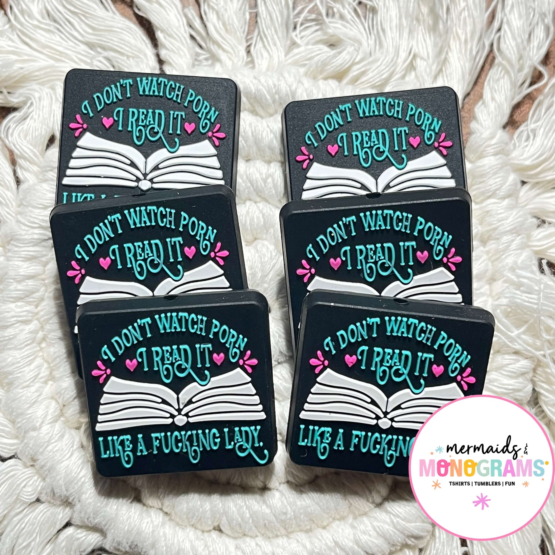 silicone beads with humorous text design on a textured white surface, featuring the brand 'Mermaid Monograms'.