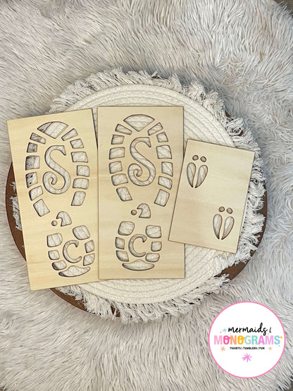 "Wooden Santa boot and reindeer footprint stencils displayed on white textured fabric – perfect for creating magical Christmas morning trails."
